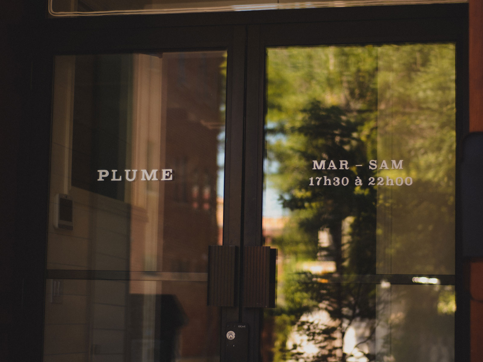 Plume restaurant doors with name and opening hours